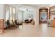Open concept living room featuring an archway, accent wall, and comfortable seating at 12565 Picadilly Rd, Commerce City, CO 80022