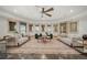 Bright living room with curved wall, plush sofas, and area rug at 12565 Picadilly Rd, Commerce City, CO 80022