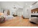 Spacious main bedroom with vaulted ceilings, hardwood floors, fireplace, and access to outdoor seating area at 12565 Picadilly Rd, Commerce City, CO 80022