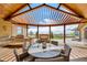 Stunning outdoor living space with pergola cover, fireplace and dining area overlooking expansive views at 12565 Picadilly Rd, Commerce City, CO 80022