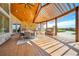 Covered outdoor patio features a dining area, fireplace, and built-in grill for entertaining at 12565 Picadilly Rd, Commerce City, CO 80022