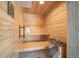 A custom sauna featuring wood paneling, tiered seating, and a stone heater for ultimate relaxation at 12565 Picadilly Rd, Commerce City, CO 80022