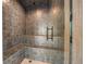 The steam room offers tiled walls and a built-in bench for a spa-like experience at home at 12565 Picadilly Rd, Commerce City, CO 80022