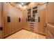 Custom walk-in closet with wood cabinetry, multiple drawers, and enclosed sections for organized storage at 12565 Picadilly Rd, Commerce City, CO 80022