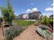 Landscaped backyard with healthy green grass, patio, and raised garden beds at 9 N Waterloo St, Aurora, CO 80018