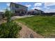 Spacious backyard with lush lawn, garden beds, and a patio, perfect for outdoor gatherings and gardening at 9 N Waterloo St, Aurora, CO 80018