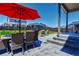 A backyard patio featuring outdoor furniture and a red umbrella, perfect for entertaining and relaxing at 9 N Waterloo St, Aurora, CO 80018
