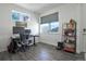 Functional home office with desk, multiple monitors, storage shelves, and natural light at 9 N Waterloo St, Aurora, CO 80018