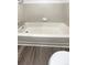 Clean bathroom with a bathtub and tile surround at 1885 S Quebec Way # B23, Denver, CO 80231