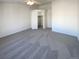 Primary bedroom with walk-in closet and carpet at 1885 S Quebec Way # B23, Denver, CO 80231
