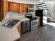 Galley kitchen with stainless steel appliances and wood cabinets at 1885 S Quebec Way # B23, Denver, CO 80231