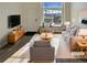 Virtually staged living room featuring modern furniture and hardwood floors at 1885 S Quebec Way # B23, Denver, CO 80231