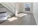 Bright living room with hardwood floors and stairs at 1885 S Quebec Way # B23, Denver, CO 80231