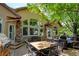 Back patio with dining and lounging areas, a gas grill, and mature trees at 11433 Decatur Ct, Westminster, CO 80234