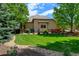 Spacious backyard featuring lush green lawn, well-maintained landscaping, and a decorative stone border at 11433 Decatur Ct, Westminster, CO 80234