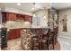 Finished basement wet bar with wine rack, stone accents, pendant lights, and seating at 11433 Decatur Ct, Westminster, CO 80234