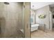 Luxurious bathroom featuring a glass shower, standalone tub, chandelier, and elegant mosaic tile at 11433 Decatur Ct, Westminster, CO 80234