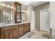 Bathroom boasts dual sinks, granite countertops, dark wood cabinetry and updated fixtures at 11433 Decatur Ct, Westminster, CO 80234