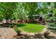 Well-manicured front yard features green lawn, landscaped garden beds, and a charming split rail fence at 11433 Decatur Ct, Westminster, CO 80234