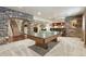 Spacious game room with ping pong table, stone archway, and wet bar area at 11433 Decatur Ct, Westminster, CO 80234
