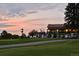 Scenic view of golf course with manicured green, golf carts lined up and a clubhouse in the background at sunset at 11433 Decatur Ct, Westminster, CO 80234