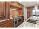 Gourmet kitchen boasts stainless steel appliances, custom cabinetry, and granite countertops at 11433 Decatur Ct, Westminster, CO 80234