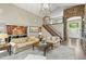 Spacious living room with open layout, hardwood floors, and a view of the foyer and staircase at 11433 Decatur Ct, Westminster, CO 80234