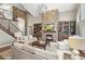 Elegant living room featuring a stone fireplace, built-in bookshelves, and comfortable seating at 11433 Decatur Ct, Westminster, CO 80234
