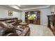 Cozy living room with plush leather seating, fireplace, and built-in entertainment center at 11433 Decatur Ct, Westminster, CO 80234