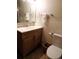 Cozy bathroom featuring a vanity, toilet, and a decorative mirror at 9625 E Center Ave # 4C, Denver, CO 80247