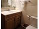 Well-lit bathroom featuring a wood vanity with a sink and a decorative hand soap dispenser at 9625 E Center Ave # 4C, Denver, CO 80247