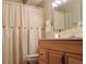 Bright bathroom with a vanity, toilet, and shower/tub combo with curtain at 9625 E Center Ave # 4C, Denver, CO 80247