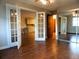 Bedroom with view into the kitchen and mirrored closet doors at 9625 E Center Ave # 4C, Denver, CO 80247