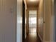 Hallway with wood floors leading to a brightly lit room at 9625 E Center Ave # 4C, Denver, CO 80247