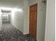 Hallway with carpet and lighting leading to the apartment units at 9625 E Center Ave # 4C, Denver, CO 80247