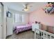 Bright bedroom with pink walls, a ceiling fan, and ample natural light perfect for a space at 2235 Coronado Pkwy # A, Denver, CO 80229