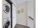 Functional hallway with a stacked washer and dryer unit and additional closet space for storage at 2235 Coronado Pkwy # A, Denver, CO 80229