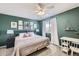 Inviting bedroom with green walls, a ceiling fan, and natural light creating a tranquil retreat at 2235 Coronado Pkwy # A, Denver, CO 80229