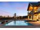 Backyard with pool, jacuzzi, and outdoor seating at dusk at 3148 Keep Dr, Sedalia, CO 80135