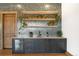 The bar area has a beverage fridge, a backsplash, wooden shelves, and plants at 3148 Keep Dr, Sedalia, CO 80135