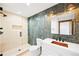 Modern bathroom featuring a walk-in shower, vanity with copper sink, and decorative wall tiles at 3148 Keep Dr, Sedalia, CO 80135
