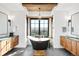 Charming bathroom with a soaking tub centered between two windows and double sink vanities at 3148 Keep Dr, Sedalia, CO 80135