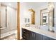 This bathroom features a glass walk-in shower, tiled floor, and modern vanity at 3148 Keep Dr, Sedalia, CO 80135