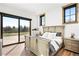 Cozy bedroom features a sliding glass door with outdoor views and natural light at 3148 Keep Dr, Sedalia, CO 80135