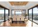 Elegant dining room with hardwood floors, ample natural light, and stunning views of the surrounding landscape at 3148 Keep Dr, Sedalia, CO 80135