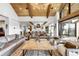 Spacious living area with a kitchen, vaulted ceilings, and expansive windows showcasing natural light and landscape at 3148 Keep Dr, Sedalia, CO 80135