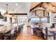 Bright living space with exposed beams, an island with barstools, and great views at 3148 Keep Dr, Sedalia, CO 80135