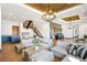 Bright living room features a modern chandelier, stylish staircase, and comfortable seating at 3148 Keep Dr, Sedalia, CO 80135