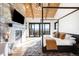 Beautiful main bedroom with four-poster bed, fireplace, exposed beams, and a balcony overlooking nature at 3148 Keep Dr, Sedalia, CO 80135