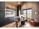 Comfortable home office with stylish wood desk, exposed beam ceiling, custom shelving, and a window at 3148 Keep Dr, Sedalia, CO 80135
